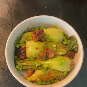 Braised baby bok choy in a white bowl